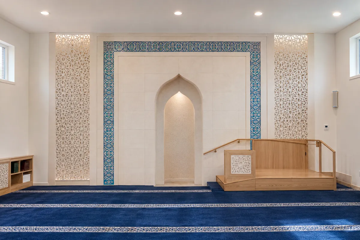 Contemporary white stone concept: pale stone mihrab with accessible timber platform